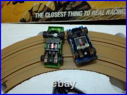 Aurora AFX Devil's Ditch Performance Track Slot Car Set Tomy Jurassic Park Truck