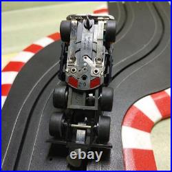 HO slot car track with guide pin front and rear, headlight lighting